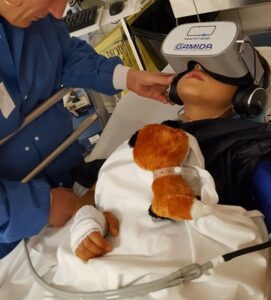 Anxious child in hospital using our partner Gamida's virtual reality headset